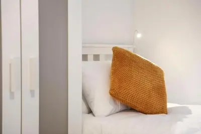 a pillow sitting on top of a bed at Baron View Apartment in Paisley