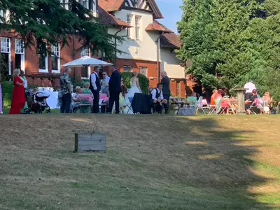 a group of people standing outside of a house at Dunmar House Hotel - Bar & Restaurant in Alloa