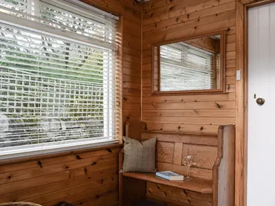 a sauna with a window and a bench at Ardchoille Cottage in Fortingall