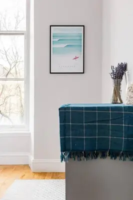 a table in a room with a picture of a beach at Incredible contemporary flat in heart of west end in Glasgow