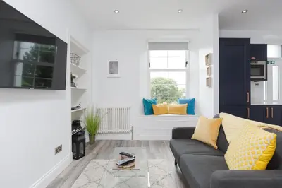 a living room with a couch and a window at Dollar Apartments-39 Bridge Street in Dollar