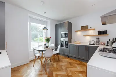 a kitchen with a table and a dining room at Dollar Apartments-41 Bridge Street in Dollar