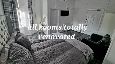 a bedroom with a bed and a couch at Windsor house in Stranraer