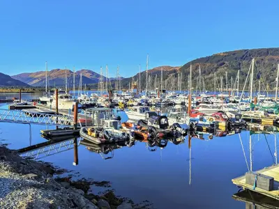 a bunch of boats are docked at a marina at Firwood Apartment in Kilmun