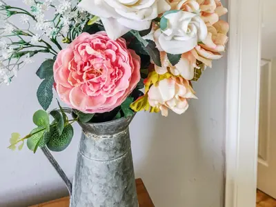 a vase with a bouquet of flowers in it at Firwood Apartment in Kilmun