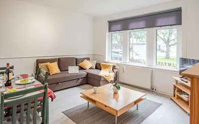 a living room with a couch and a table at Stirling Mercury Apartment - Scotland Holiday Let in Stirling