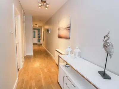 a room with a white counter with two bottles on it at Cumbrae View in Largs