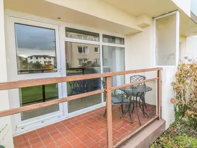 a balcony with a table and chairs on it at Cumbrae View in Largs