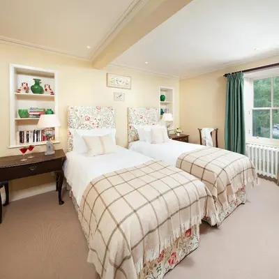 a bedroom with two beds and a window at The Loch Lomond Arms Hotel in Luss