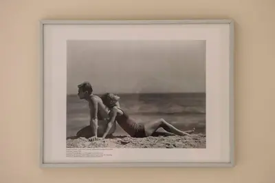 a picture of a couple sitting on the beach at JOIVY Bright 1 bed flat, close to Princess Street in Edinburgh