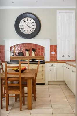 a kitchen with a table and a clock on the wall at Balmule House in Dunfermline