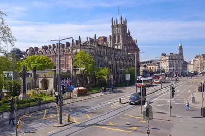 a busy city street with a large building with a cathedral at Destiny Scotland Charlotte Square Apartments in Edinburgh
