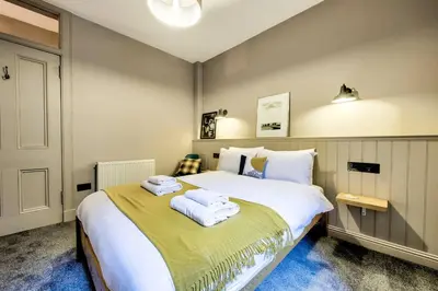 a bedroom with a large bed with towels on it at GuestReady - Stylish 2BR in Heart of Tollcross in Edinburgh