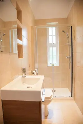 a bathroom with a sink and a shower and a toilet at The Gardener's Cottage in Dunblane
