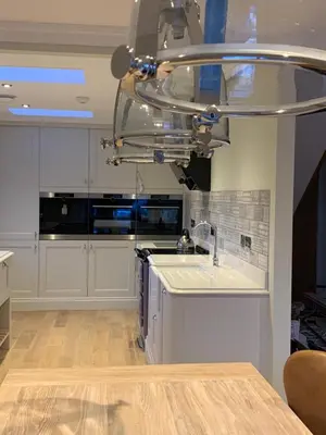 a kitchen with white cabinets and a sink at Stormfront Luxury Hideaway Glencoe Ballachulish Highlands Near Fortwilliam in Glencoe
