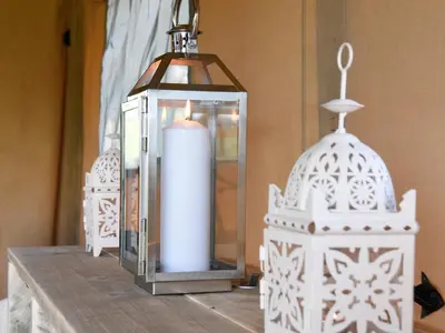 a candle and a lantern on a table at Carr's Hill Luxury Safari Tents in Denny