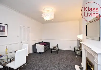 a living room with a couch and a table at Whifflet Apartment by Klass Living Coatbridge in Coatbridge