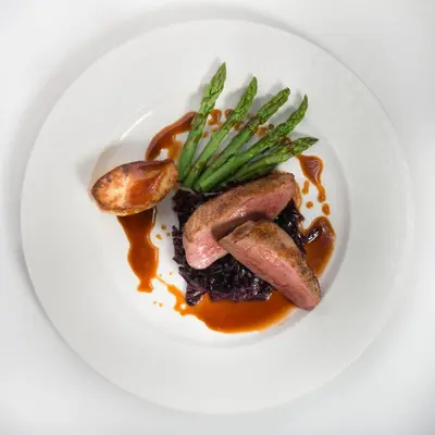 a plate of food with meat and mushrooms and sauce at Glencoe House in Glencoe