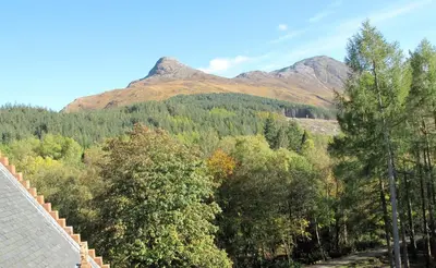a view from the roof of a house with trees and mountains at Glencoe House in Glencoe