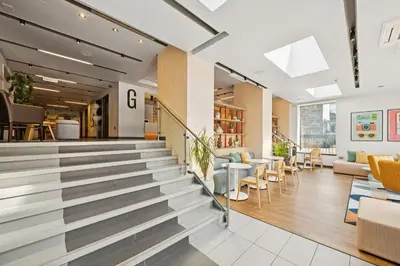 a lobby of a building with chairs and tables at Garner Hotel Edinburgh - Haymarket by IHG in Edinburgh