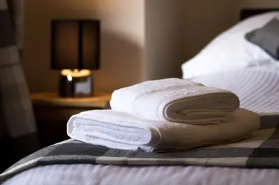 a group of towels sitting on top of a bed at 1 Balnakeil, Kirk Road in Oban