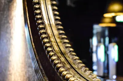 a close up of a mirror with a gold frame at Dalziel Park Hotel in Motherwell
