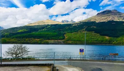 a view of a lake with mountains in the background at Rowantreebank Bed and Breakfast in Arrochar
