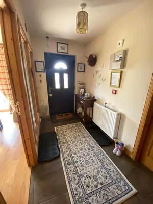 a hallway with a black door and a rug at Shenavallie Farm in Benderloch