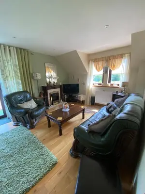 a living room with a couch and chairs and a table at Shenavallie Farm in Benderloch