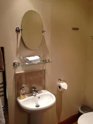 a bathroom with a sink and a mirror on the wall at The Woolly Rock in North Ballachulish