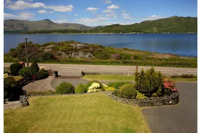 a park with a view of a body of water at Ardno House B & B in Glencoe