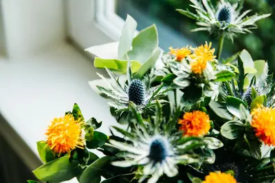 a bouquet of flowers sitting on a window sill at Altavona House in Oban