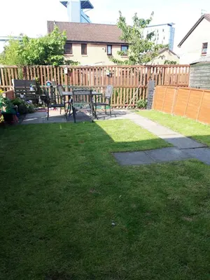 a patio with a table and chairs in a yard at Hardgate Gardens in Glasgow