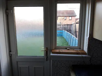 a door with a window and a view of the ocean at Hardgate Gardens in Glasgow