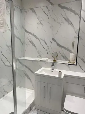 a white bathroom with a sink and a shower at Welltrees Apartments 14 Dailly Road Maybole in Maybole