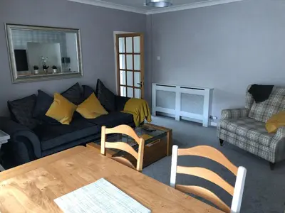 a living room with a couch and a table at Old Police House Causewayhead Stirling in Stirling