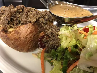a plate of food with a salad and dip at The Drymen Inn in Drymen