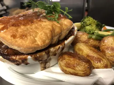 a plate with a sandwich and potatoes and broccoli at The Drymen Inn in Drymen