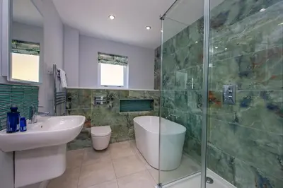 a bathroom with a sink and a glass shower at Seabank House in Oban