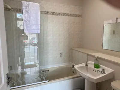 a bathroom with a sink and a bath tub and a sink at Welltrees Apartments 8 Dailly Road in Maybole