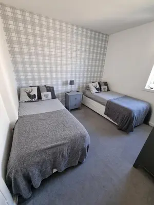 a bedroom with two beds and a window at Bespoke Tours Scotland Accommodation @ Morrison Street in Edinburgh