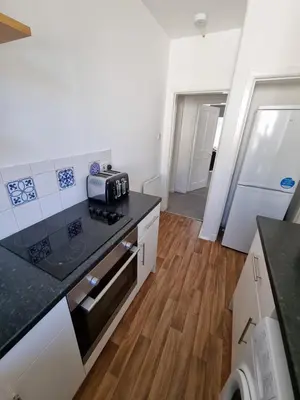 a kitchen with a counter top and a stove top oven at Bespoke Tours Scotland Accommodation @ Morrison Street in Edinburgh