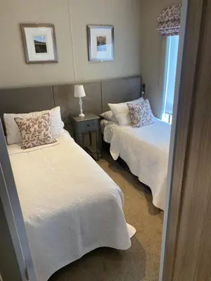 a bedroom with two beds and a table with a lamp at Brightwater Lodge in Dunning