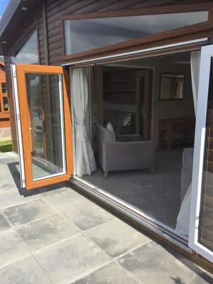 a sliding glass door of a living room with a couch at Brightwater Lodge in Dunning