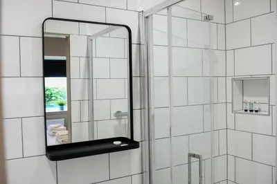 a bathroom with a mirror and a shower at Raniven in Oban