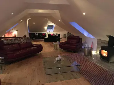 a living room with two couches and a table at Invercreran Lodge Luxury Bed & Breakfast in Appin