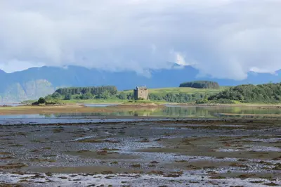 a castle in the middle of a body of water at Sealladh in Port Appin