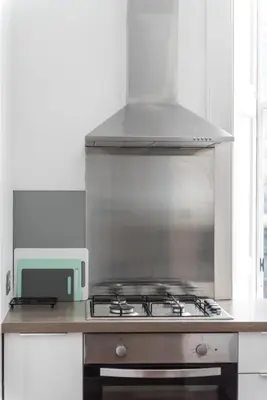 a stove top oven in a kitchen with a microwave at Charming, Central & Spacious Georgian 3 bed APT in Edinburgh