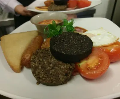 a plate of food with hamburgers and other foods at The Fairburn Hotel in Mauchline