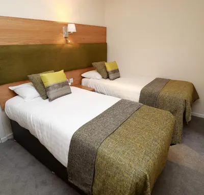 a hotel room with two beds in a room at The Famous Star Hotel Moffat in Moffat